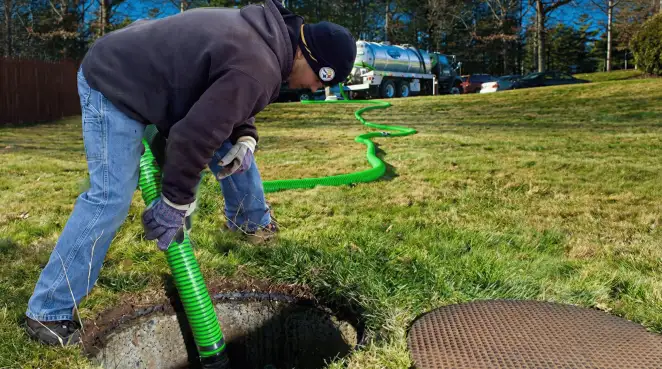 Service technician performing residential septic pumping and drainage maintenance in Reno, NV